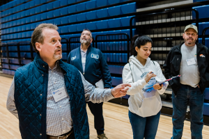 Conference attendee asks a question during the Rec Hall walkthrough